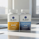 Two bottles of Dr. Emil Nutrition supplements on a desk with a blurred office background.