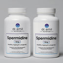 Two bottles of Dr. Emil Nutrition Spermidine supplement on a gray background