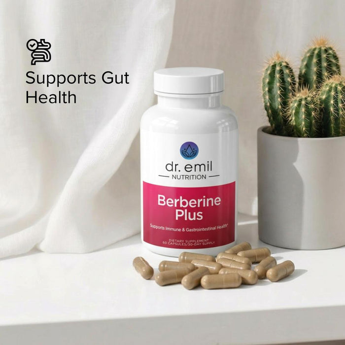 Bottle of dr. emil Nutrition Berberine Plus supplement with capsules on a surface next to a cactus.