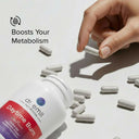 Hand picking up a supplement capsule with 'dr. emil' bottle and text about boosting metabolism on a white background.