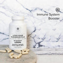 Bottle of Lions Mane Mushroom Plus supplement with capsules on a marble surface, labeled as an immune system booster.