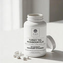 White supplement bottle labeled 'Elite Turkey Tail Mushroom Plus' by Dr. Emil on a light background