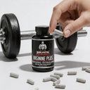 Bottle of Goliath by Dr. Evil Arginine Plus with a hand holding a dumbbell and scattered capsules on a light background.