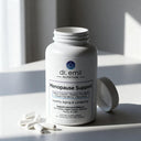 Dr. Emil Nutrition Menopause Support supplement bottle on a light surface with sunlight casting shadows.