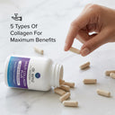 Hand picking a collagen supplement capsule from an open bottle labeled 'dr. emil nutrition' on a marble surface.