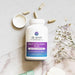 Dr. Emil Nutrition Multi Collagen Plus supplement bottle on a marble surface with capsules and flowers.