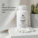 Dr. Emil NAD+ Boost supplement bottle with capsules on a light surface, featuring text about niacin and copper benefits.