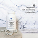 Dr. Emil NAD+ Boost supplement bottle with capsules on a marble surface, text indicating metabolism support.