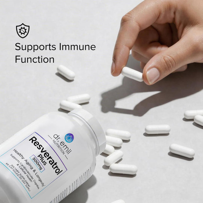 Hand picking up a Resveratrol supplement capsule with a bottle of supplements on a light background.